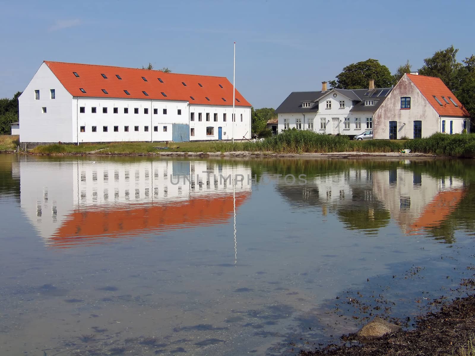 Mansion big farmhouse reflected in the sea Funen Denmark