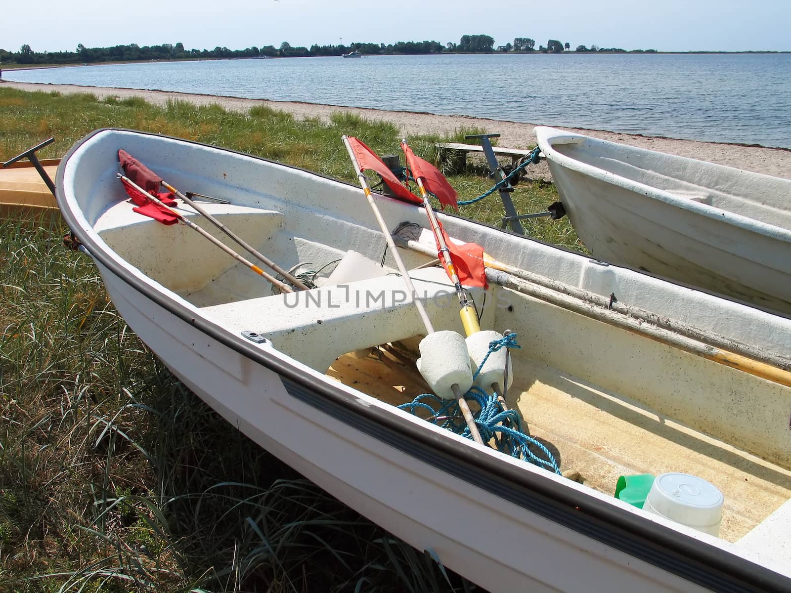 Small fishing boats an equipment on the shore Funen Denmark