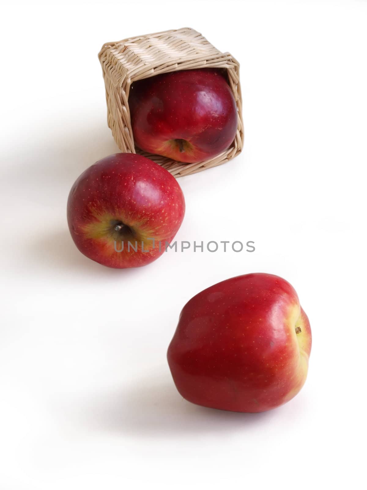 Red apples and basket on a white background 