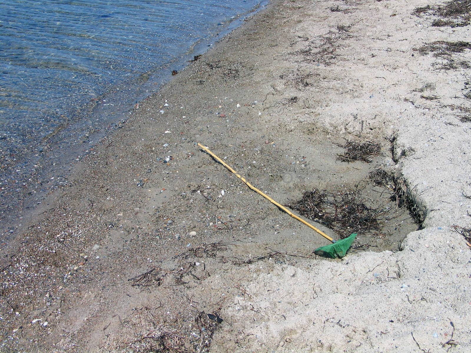 Children's toy fishing net on the beach