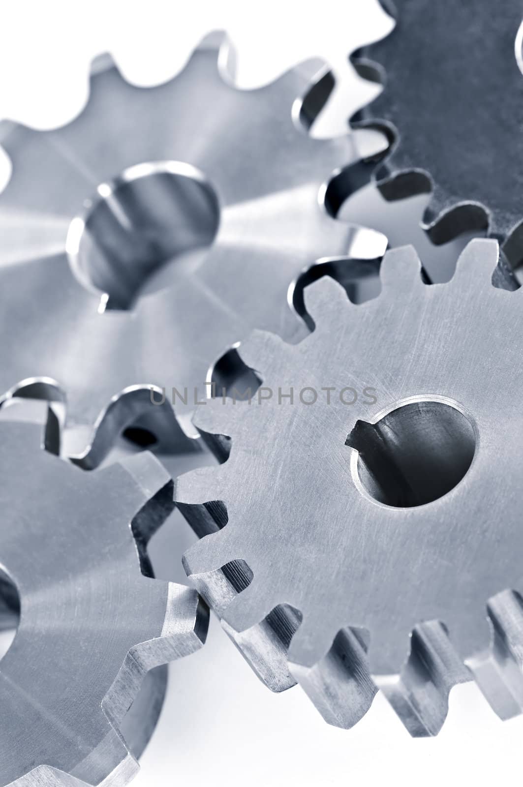 Interlocking industrial metal gears isolated on white