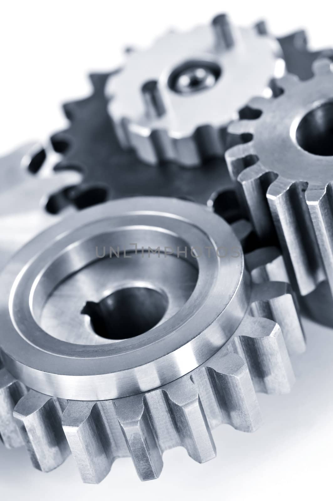 Interlocking industrial metal gears isolated on white