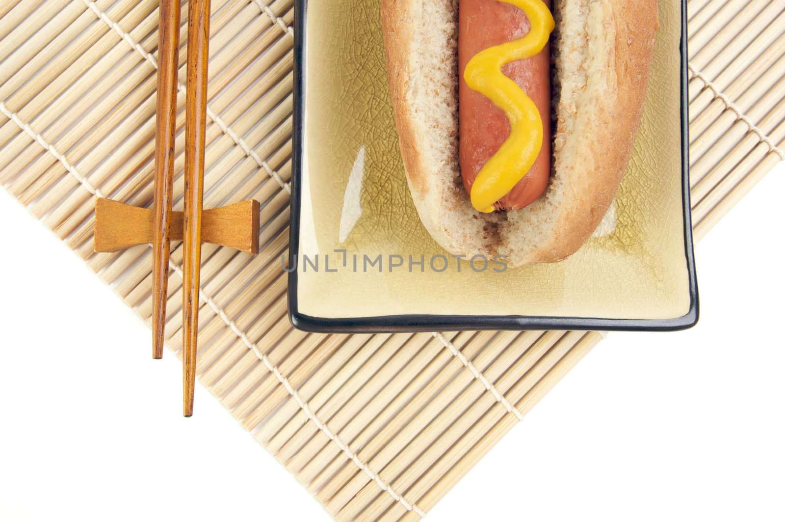 East Meets West - Hot Dog and Chopsticks Isolated on a White Background