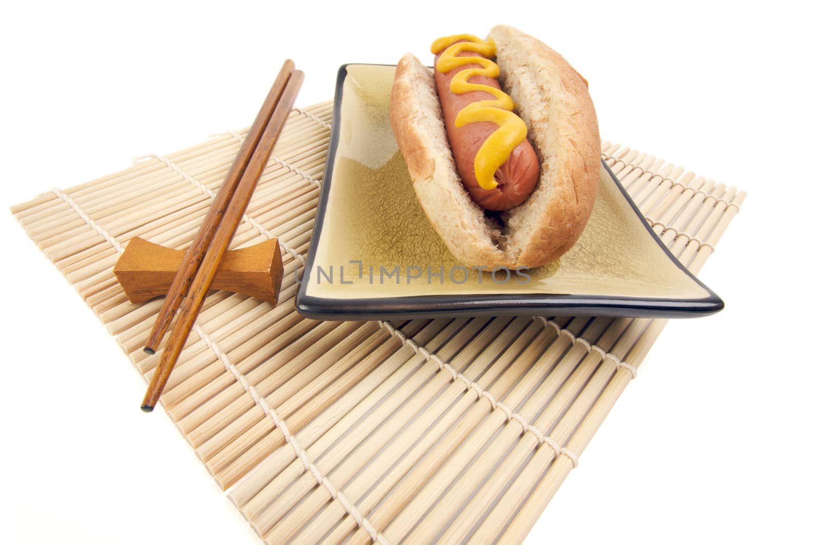 East Meets West - Hot Dog and Chopsticks Isolated on a White Background