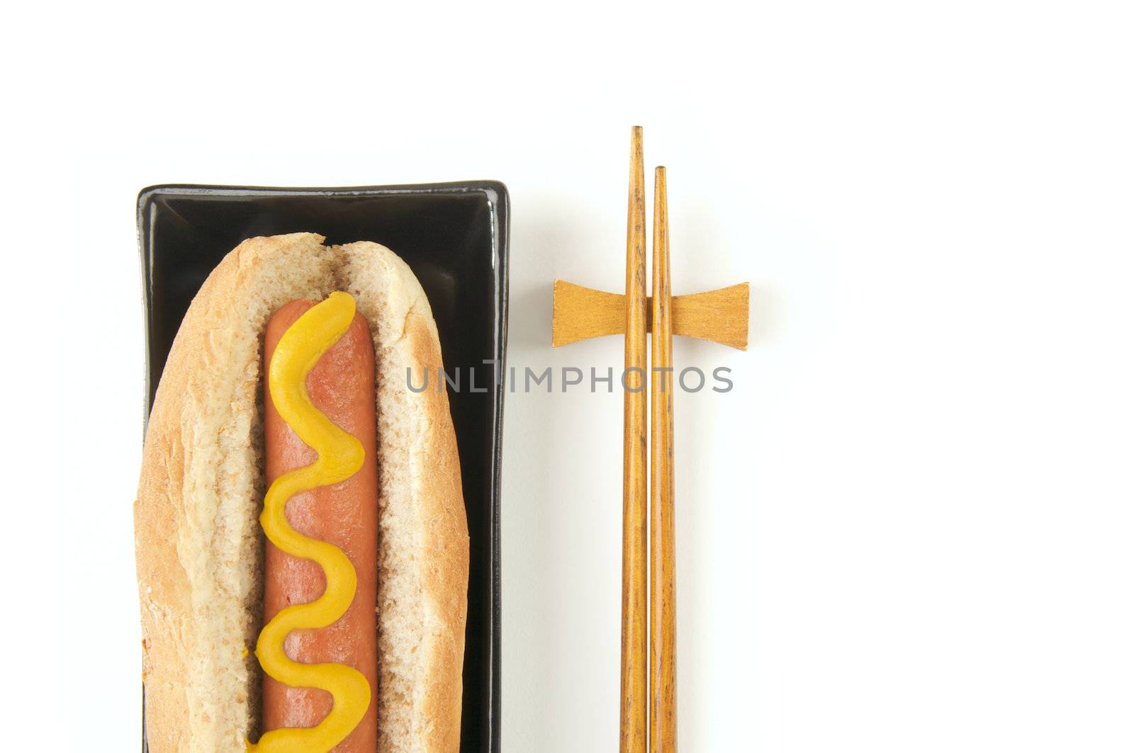 East Meets West - Hot Dog and Chopsticks Isolated on a White Background