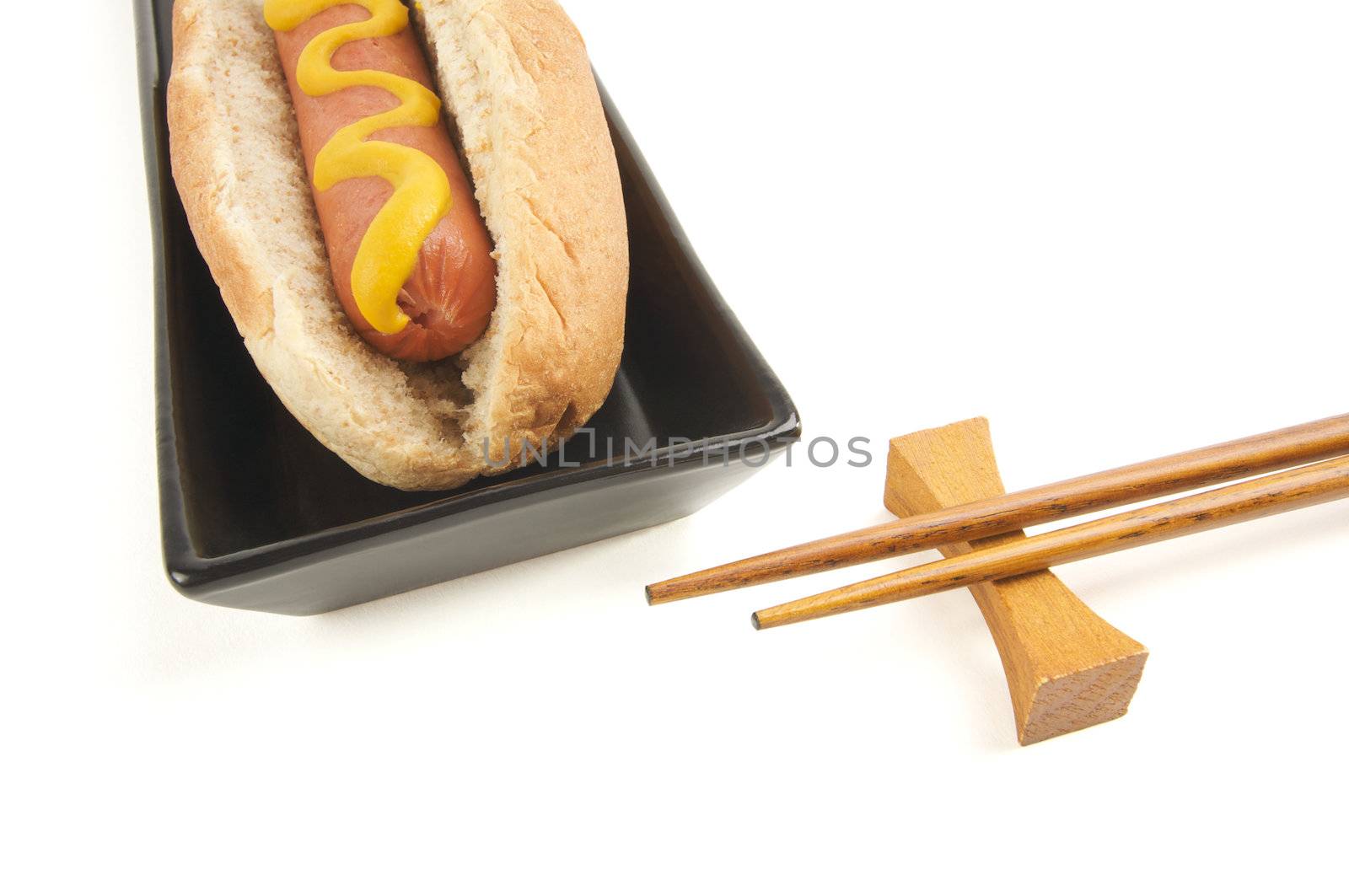East Meets West - Hot Dog and Chopsticks Isolated on a White Background
