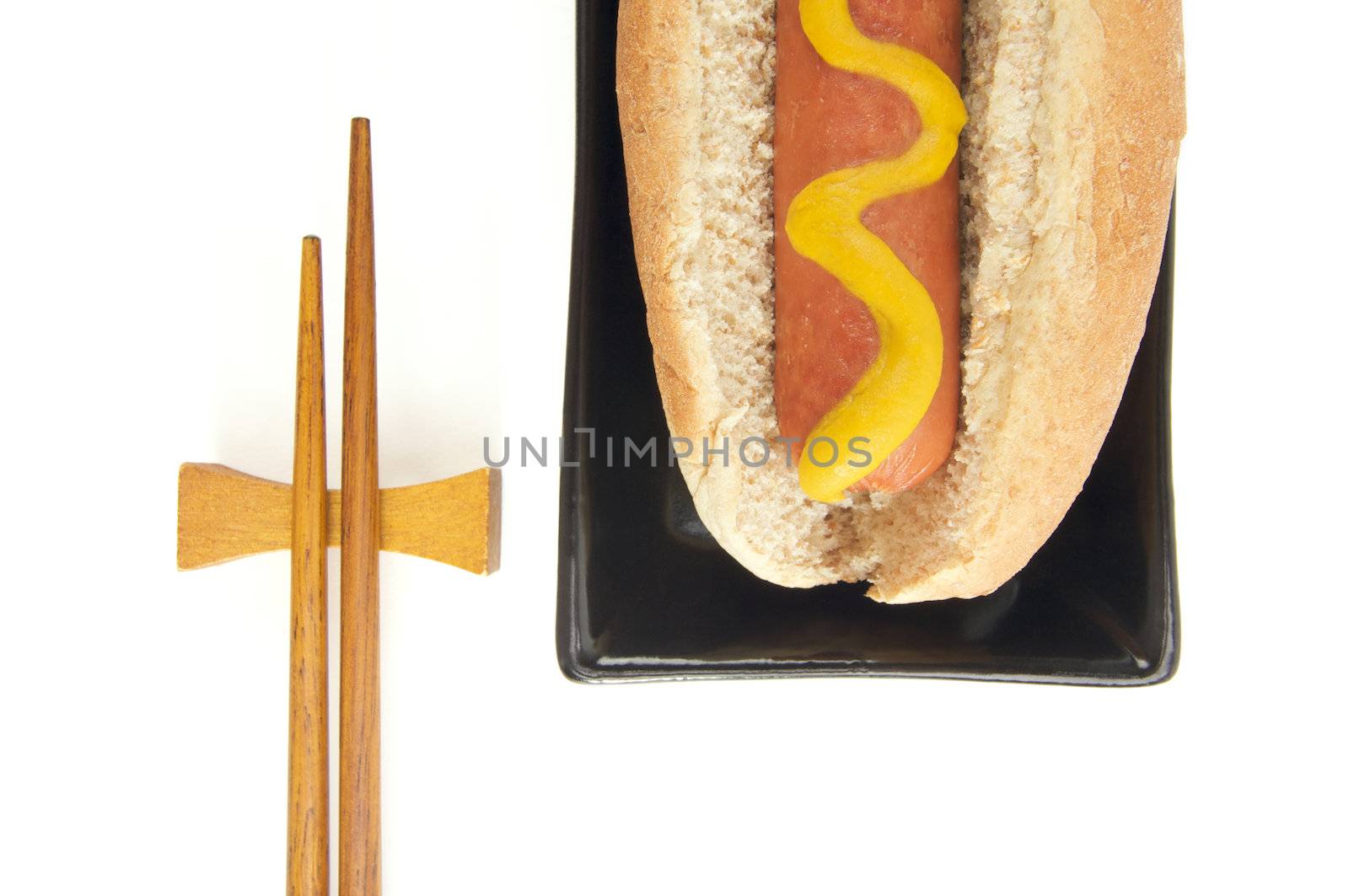 East Meets West - Hot Dog and Chopsticks Isolated on a White Background