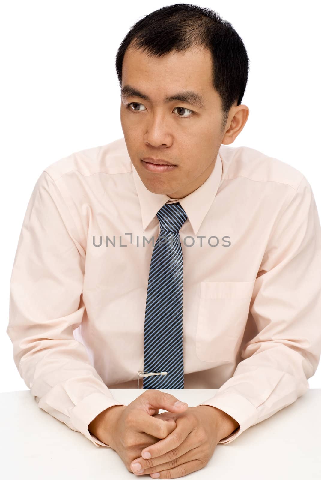 Businessman sit and watch, put hands on white table.