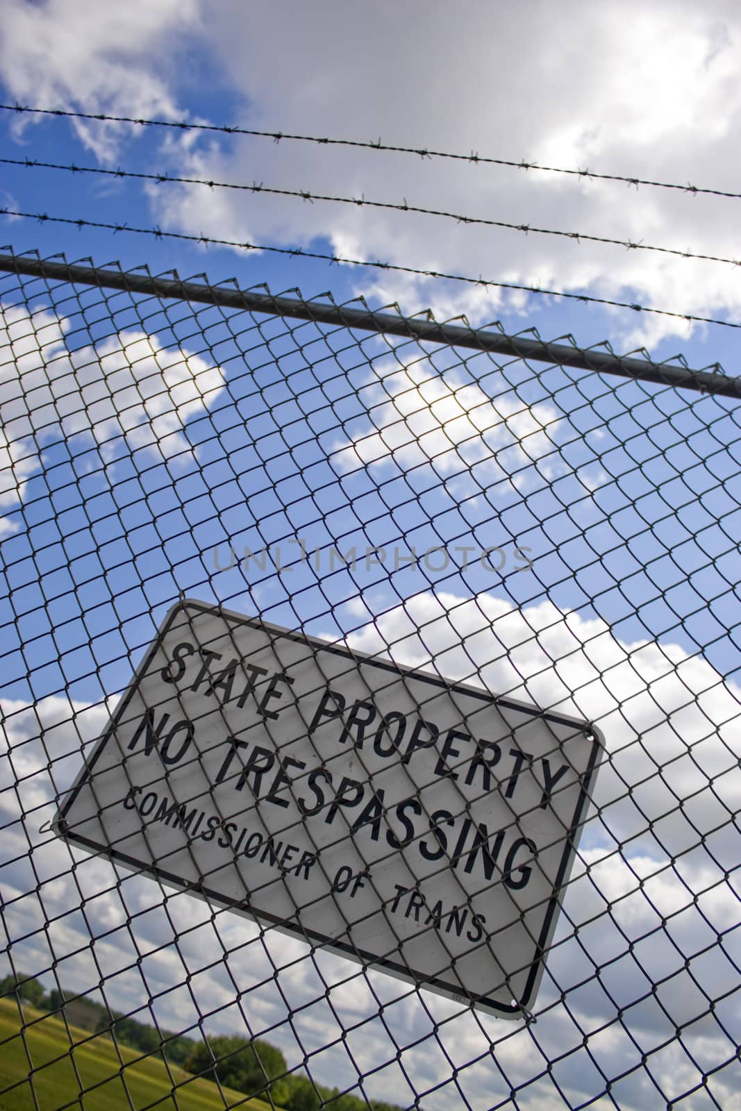 A no trespassing sign that reads STATE PROPERTY NO TRESPASSING outside an airport.