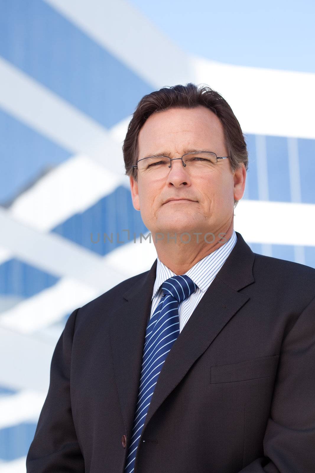 Handsome, Confident Businessman Outside of Corporate Building in Suit and Tie.