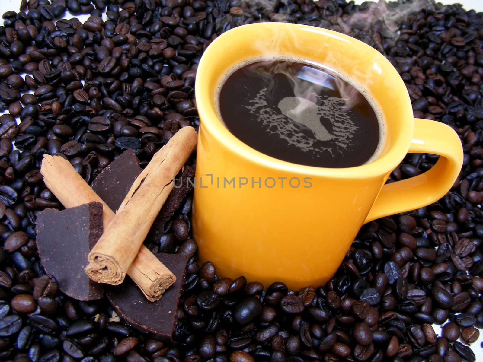 coffee cup with beans,chocolate and cinnamon