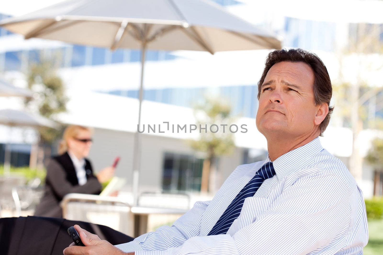 Handsome Businessman Looks Off Into the Distance by Feverpitched