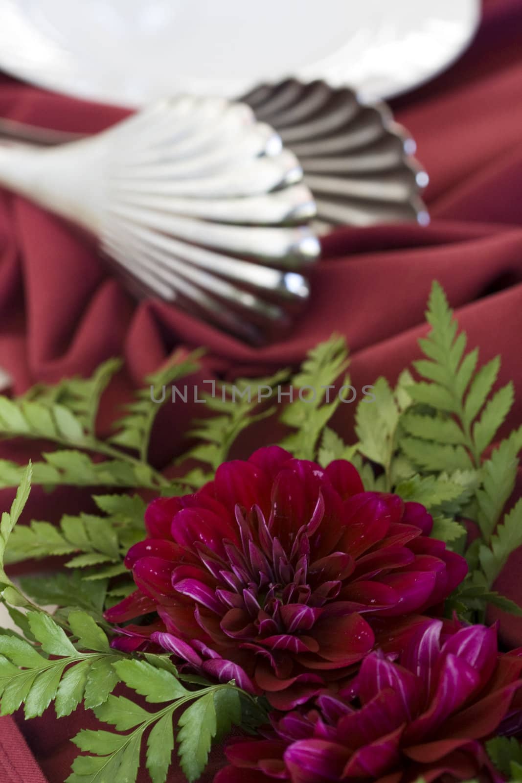 silver utensils and flowers on catering table