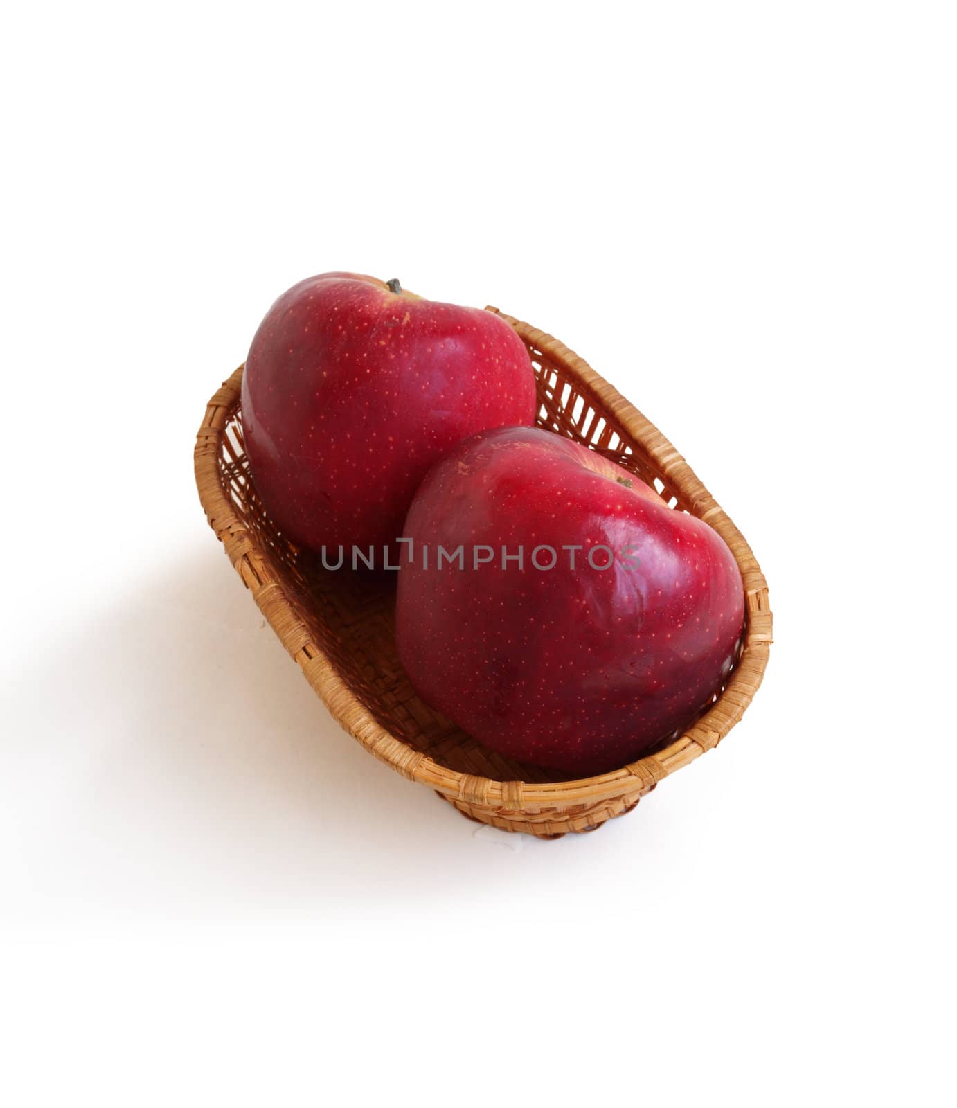 Two apples in a basket on a white background