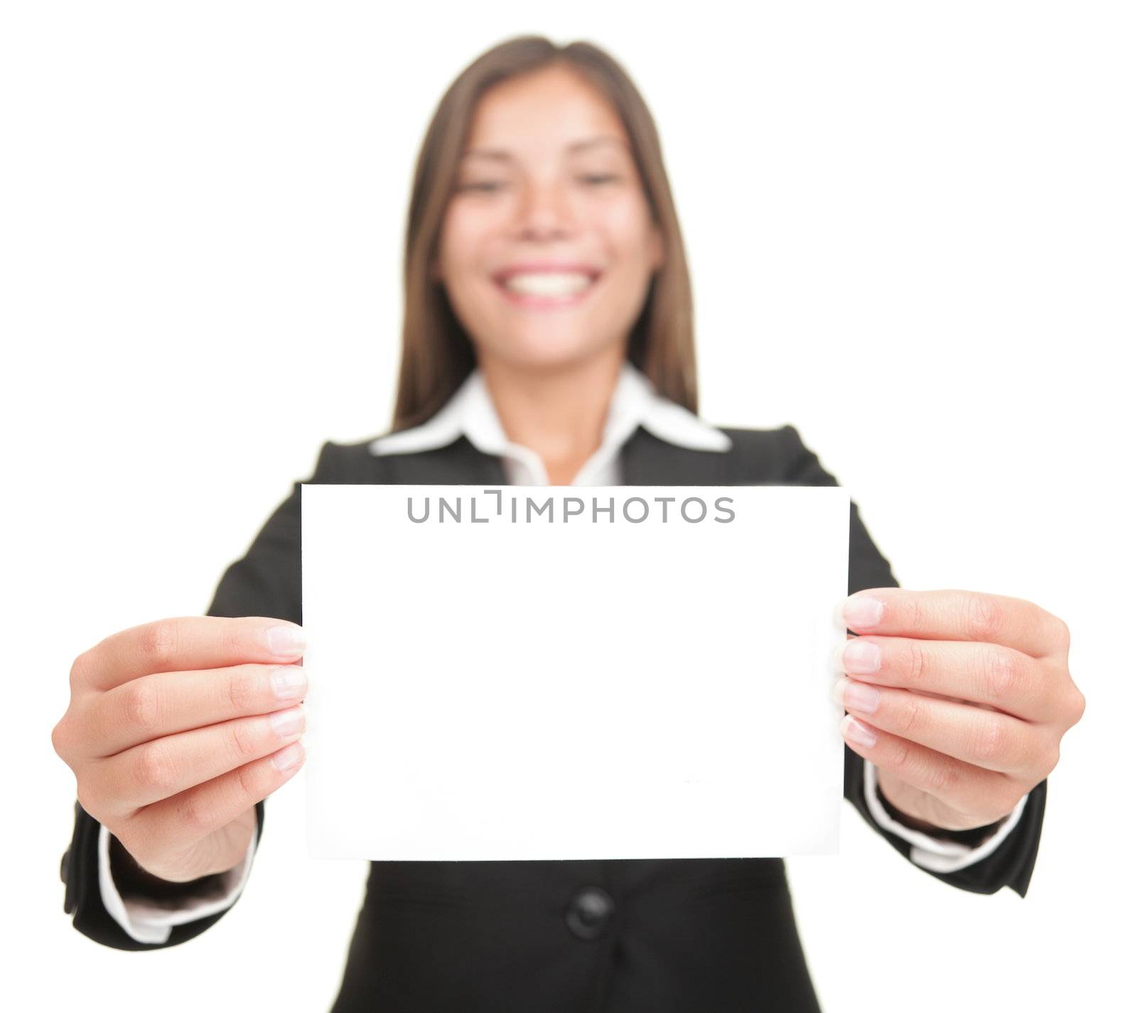 Businesswoman smiling holding empty blank sign. Excited version also available,  Beautiful mixed chinese asian / caucasian business woman. Isolated on seamless white background.