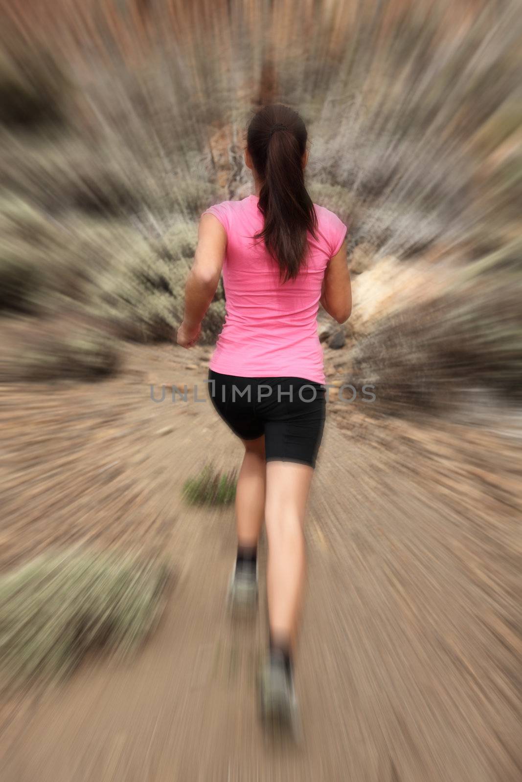 Running - woman runner in motion zoom blur for speed effect. Female running outside in desert.