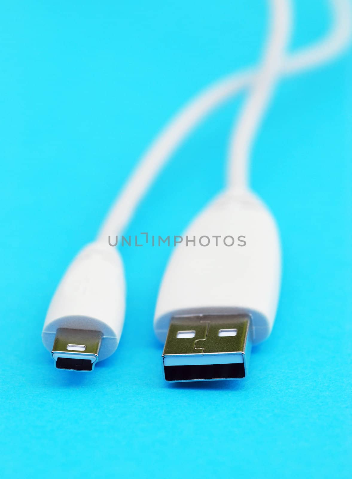 Closeup of white usb cable on blue background