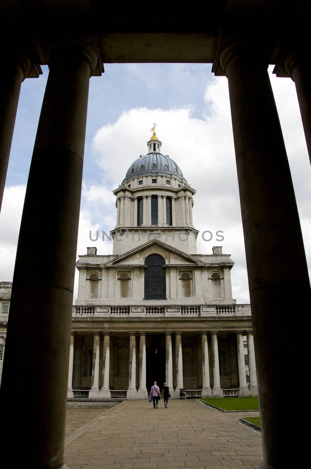 A building with a dome on top framed y two columns