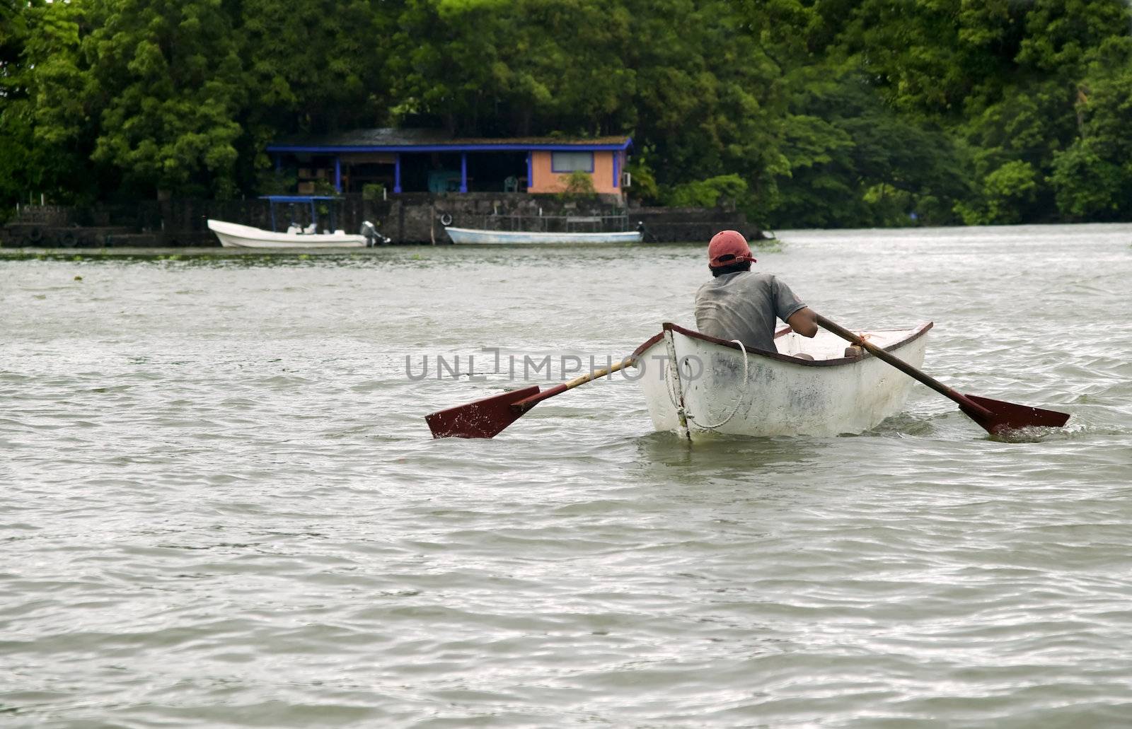 Man rowing a small boat on Lake Nicaragua