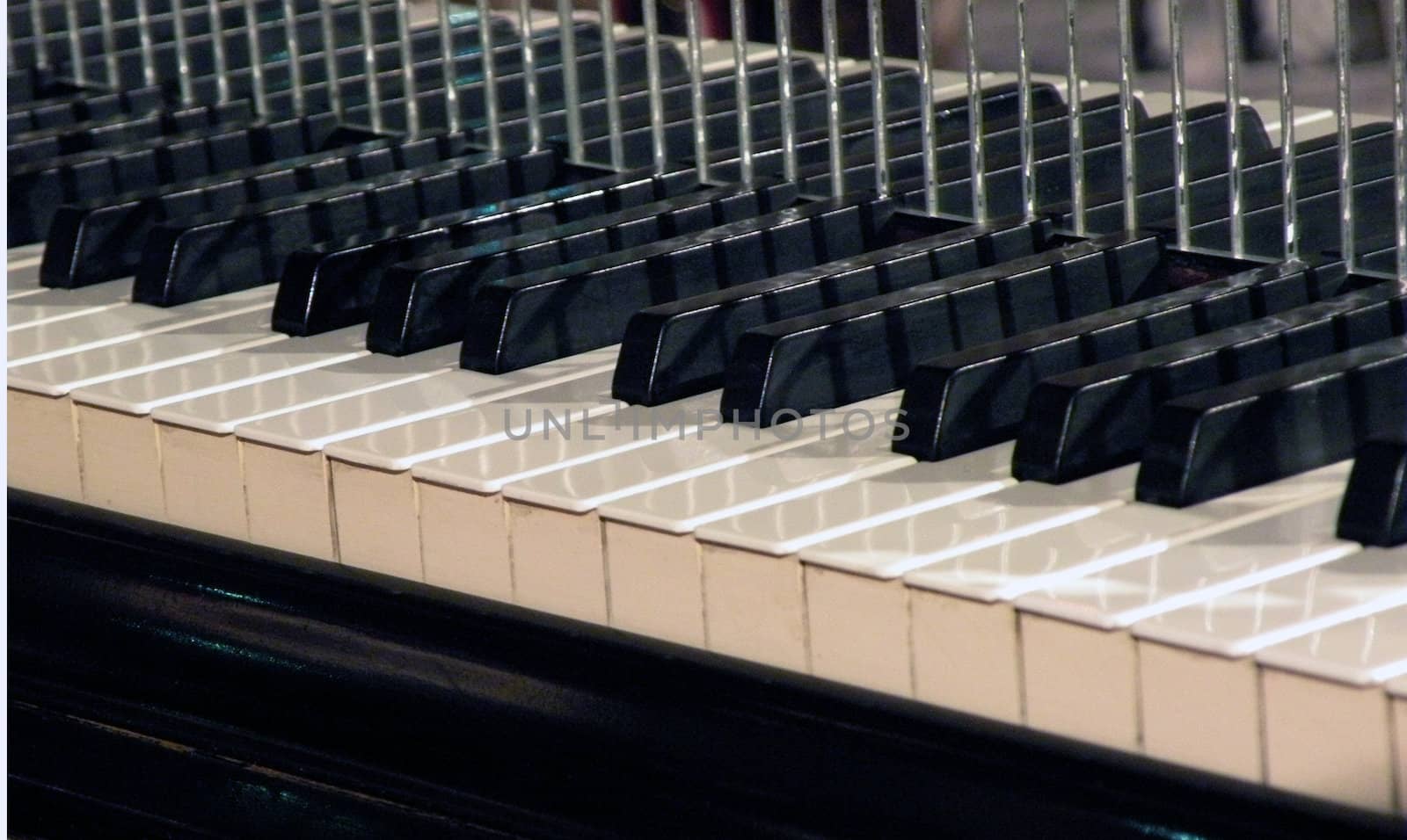 a piano keyboard with reflective mirror mounted behind it.