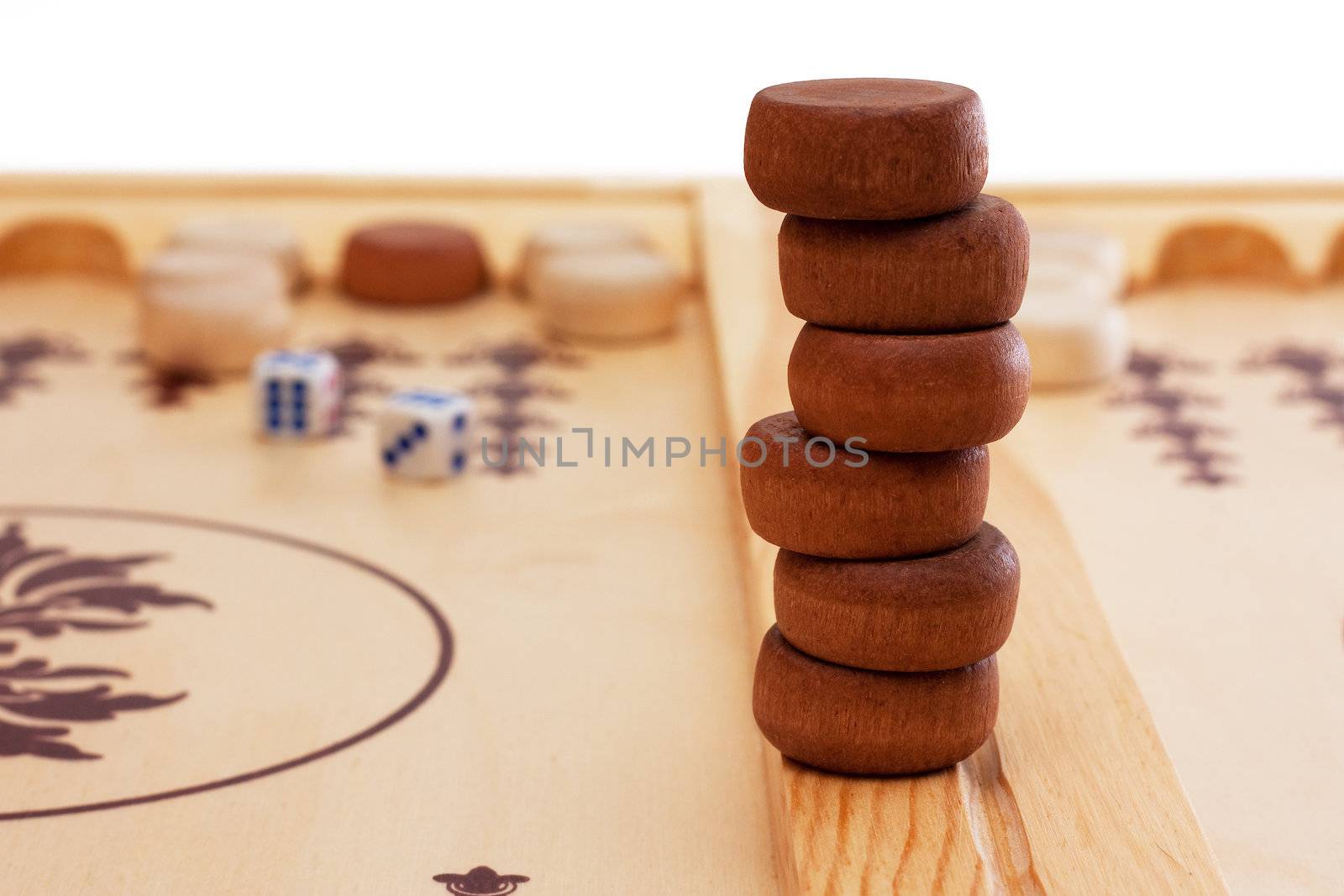 A stack of game pieces at a backgammon board