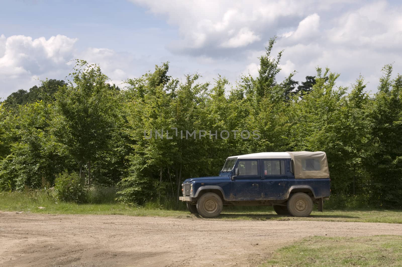 A four wheel drive truck on a farm track