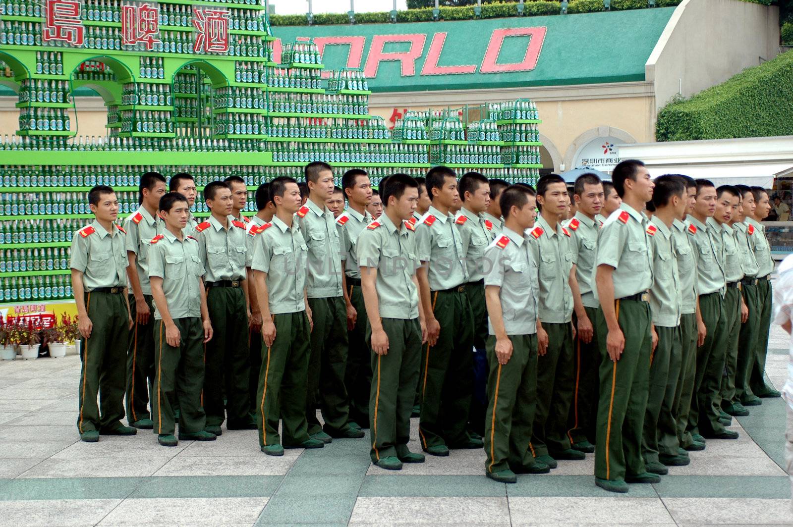 Chinese soldiers during outdoor trip, gathering in front of Window of The World, Shenzhen, China.