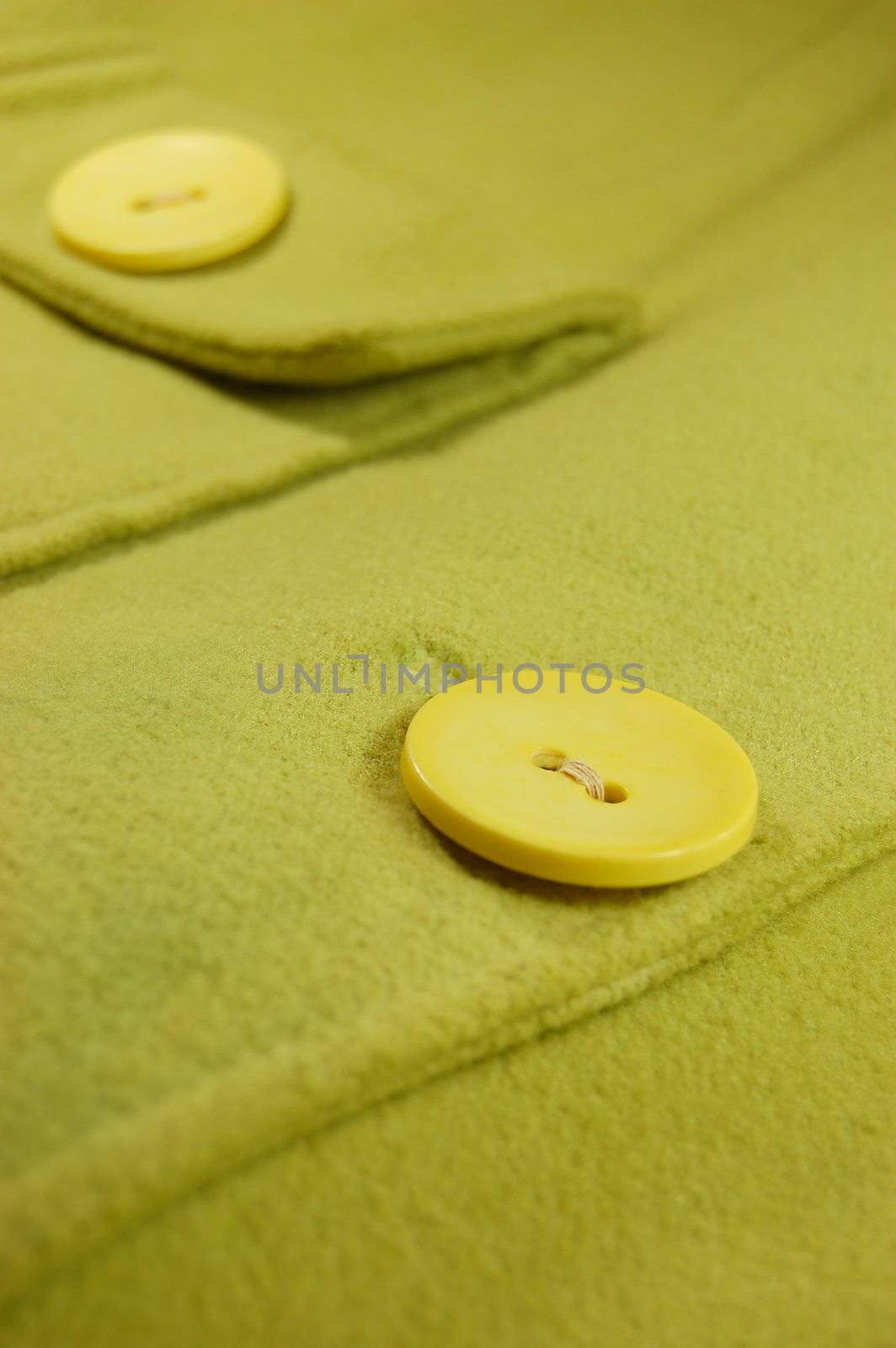woolen piece of textile with big yellow buttons