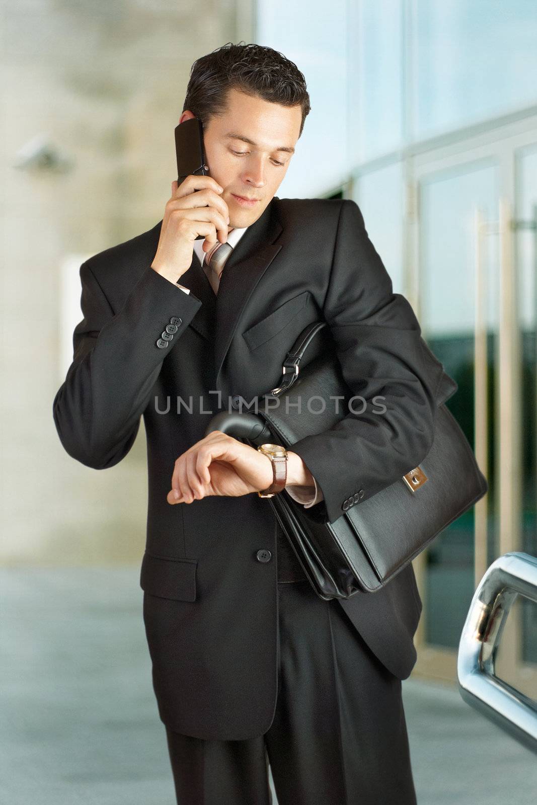 Businessman outside a modern building by DmitryYakunin