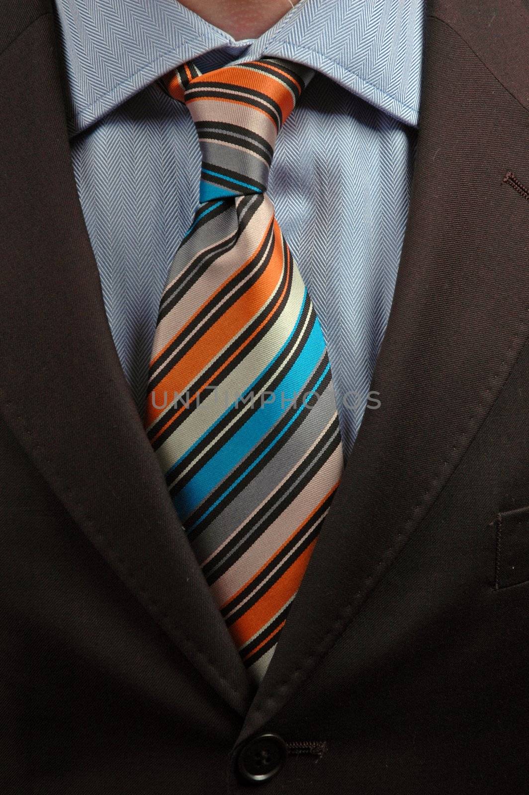 detail of a Business man Suit with orange and blue tie