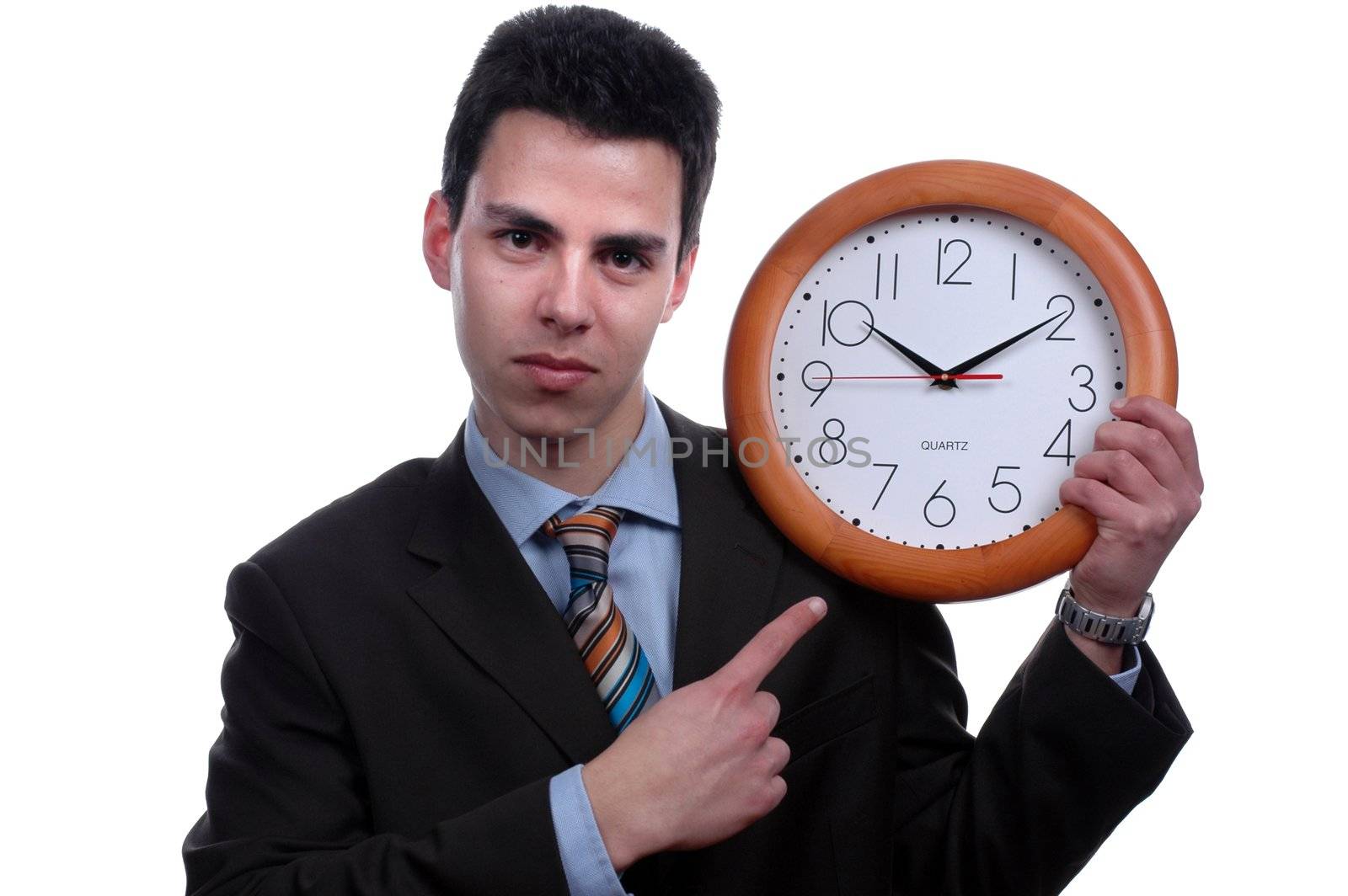 young businessman poiting to wall clock