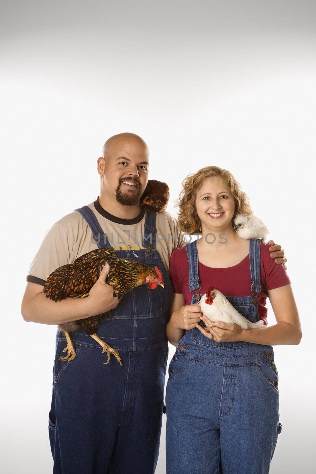 Woman and man with chickens. by iofoto
