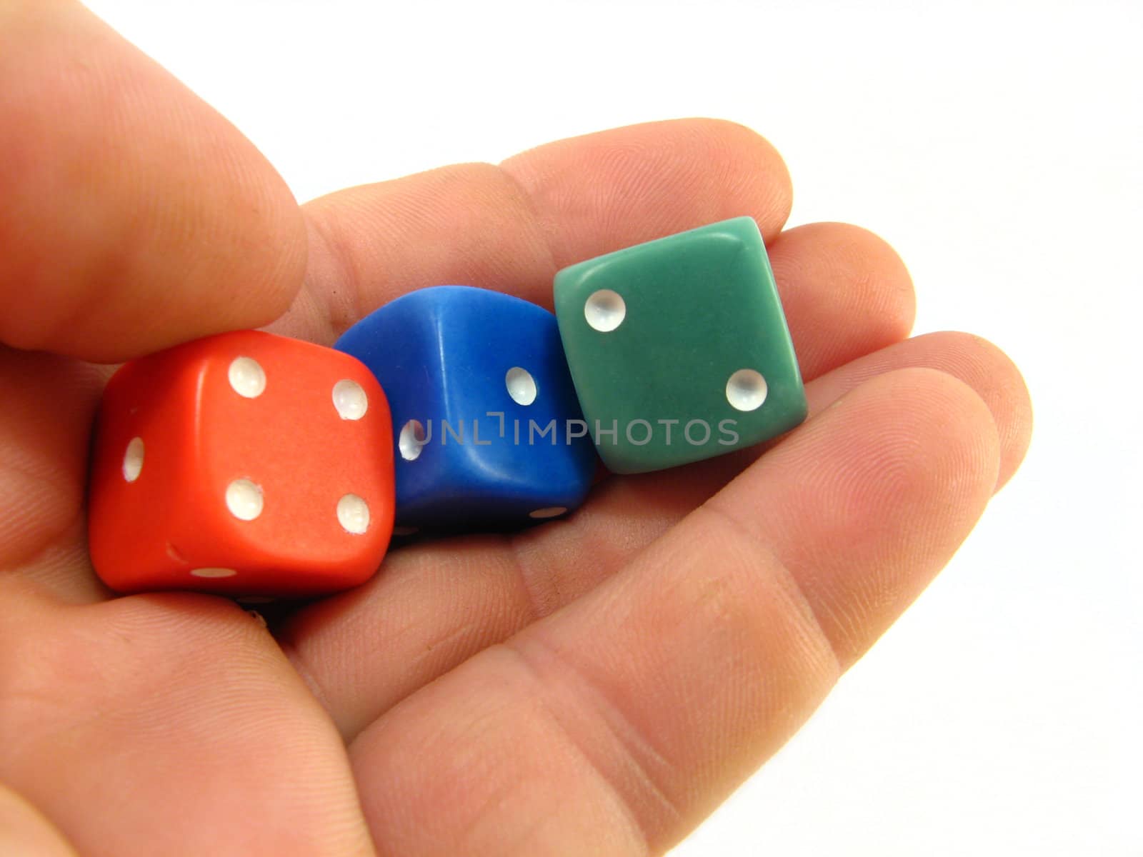 hand holding red, blue and green dices