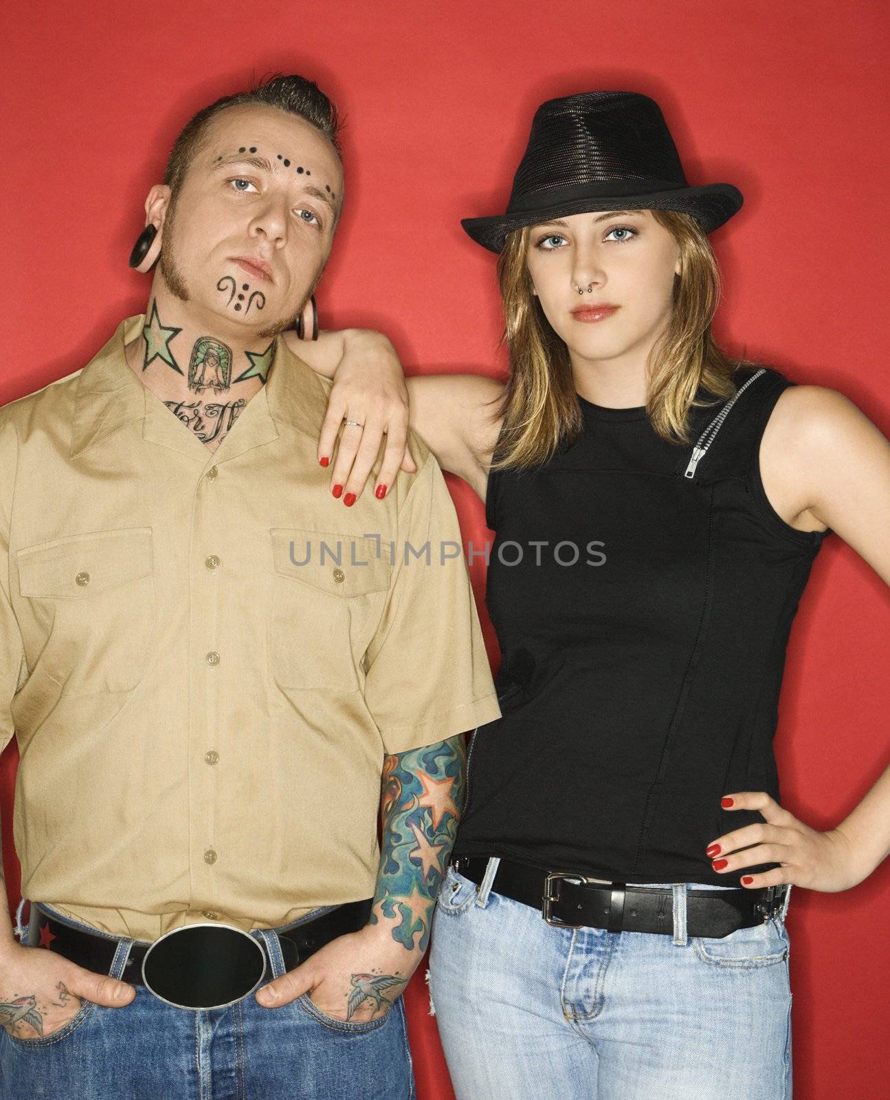 Caucasian mid-adult man and teen female standing together looking at viewer.