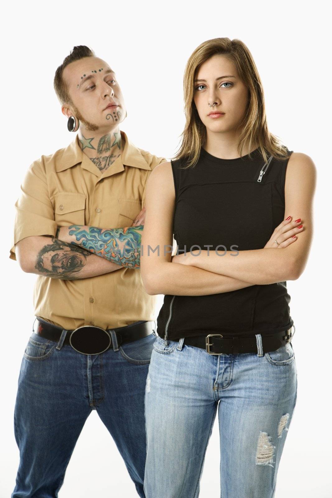 Caucasian mid-adult man looking at teen female who is looking away.