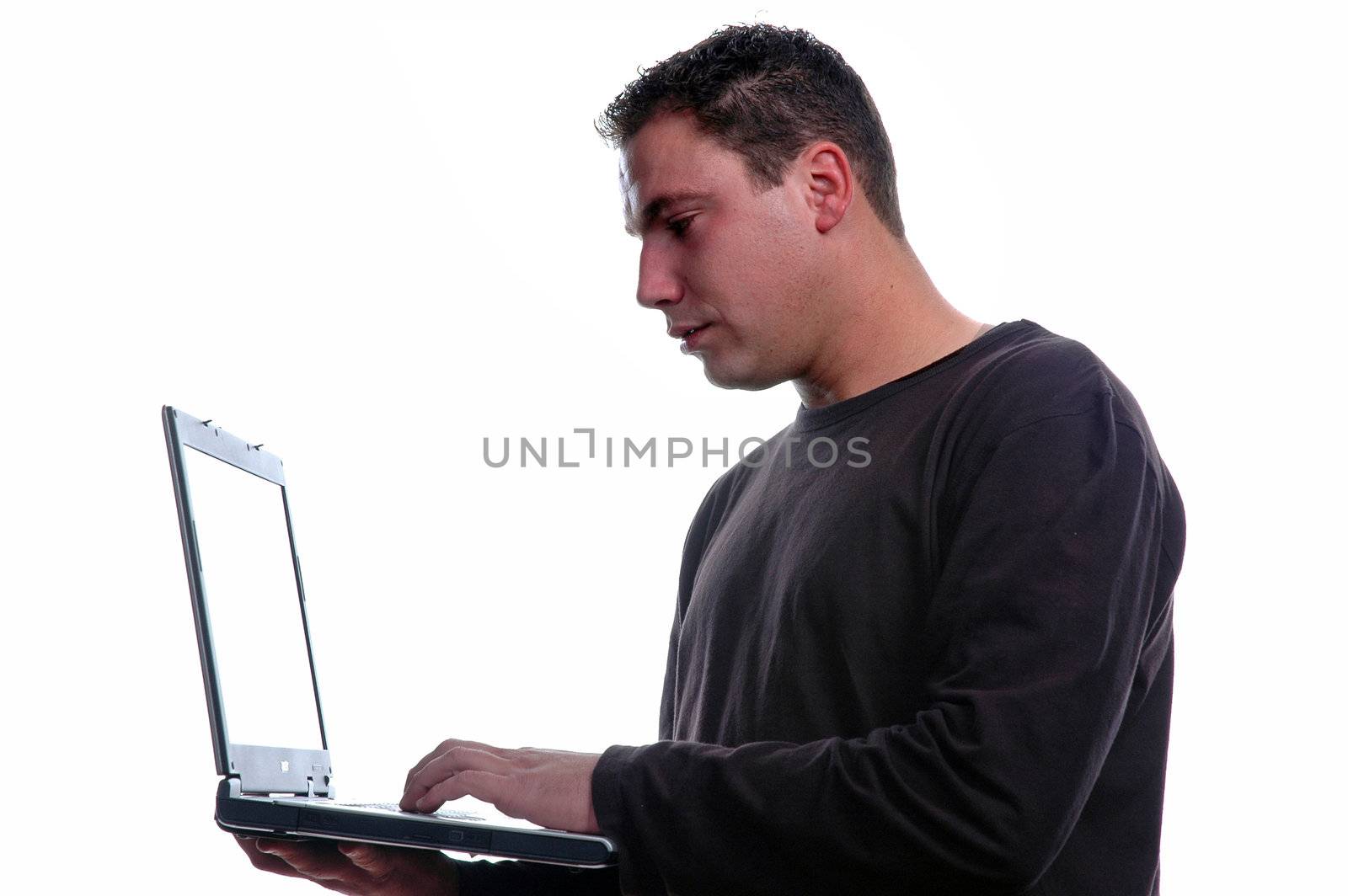 young man isolated over white holding laptop by raalves