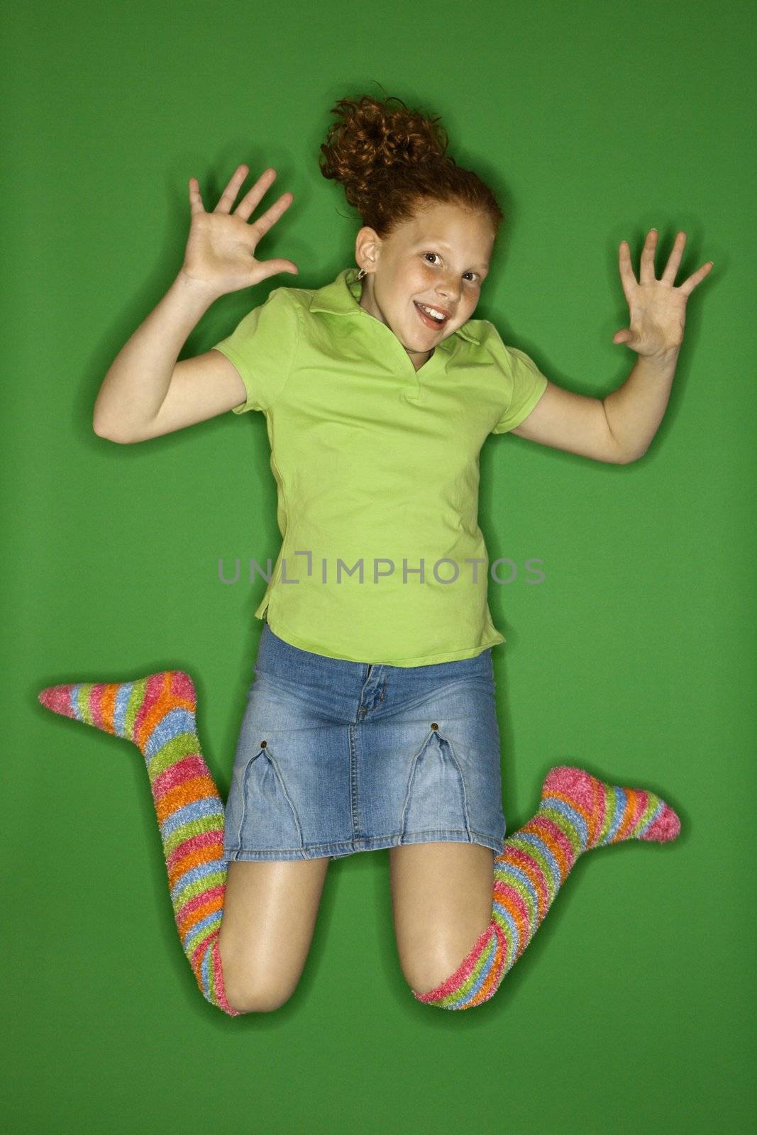 Caucasian female child jumping.