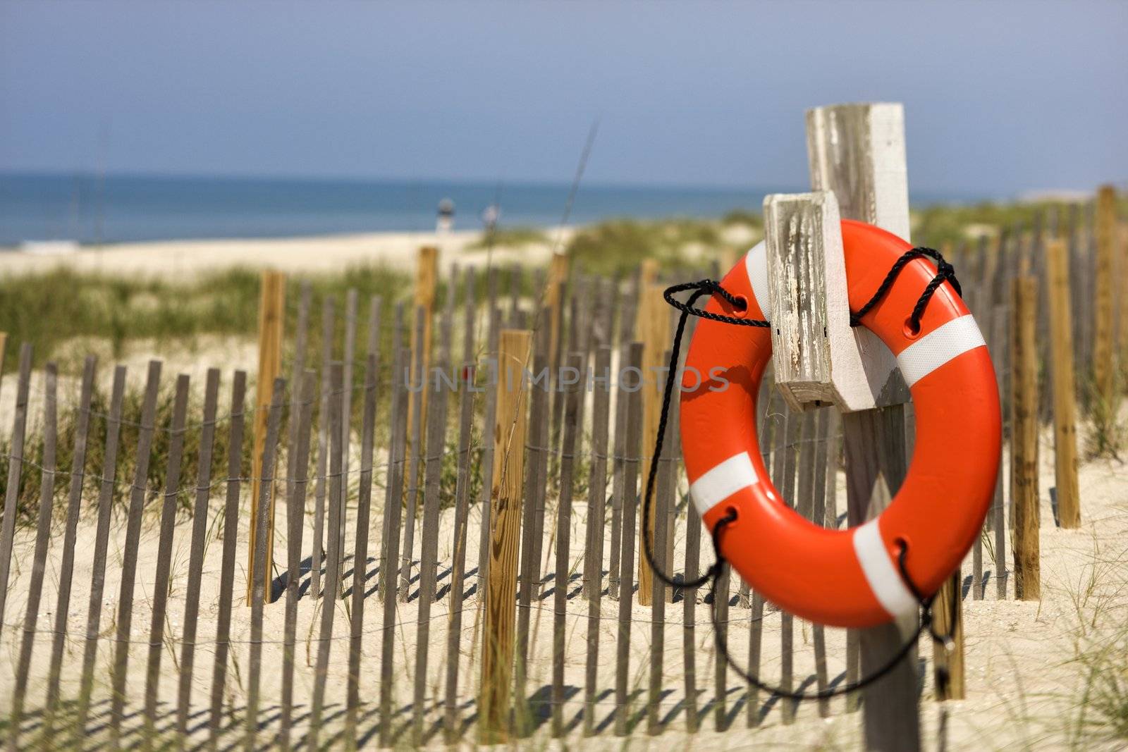 Life preserver hanging on post on beach on Bald Head Island, North Carolina.