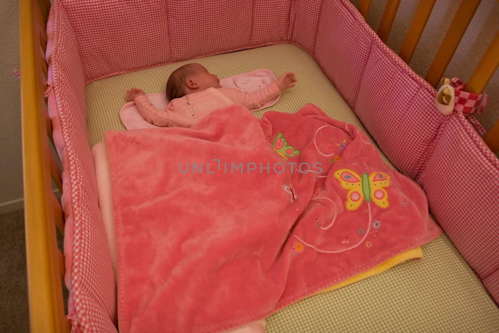 3 weeks old newborn girl sleeping on her back.