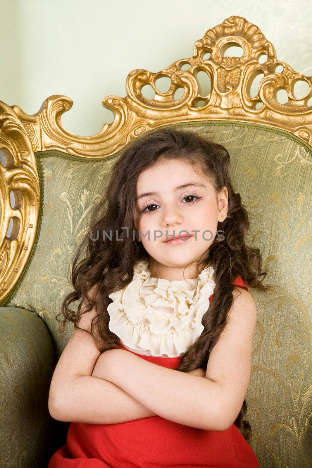 small girl with long hair in the armchair