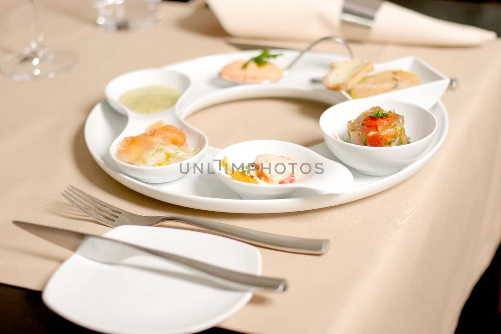 Starter or Entree of a french dish with fish, seafood mixed and foie gras