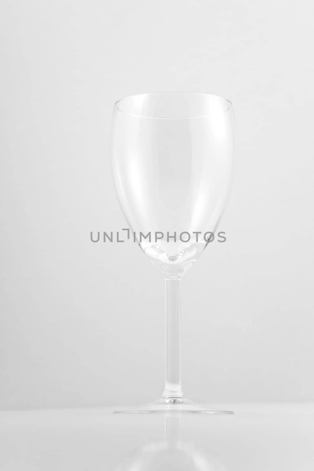 Empty white wine glass on white background