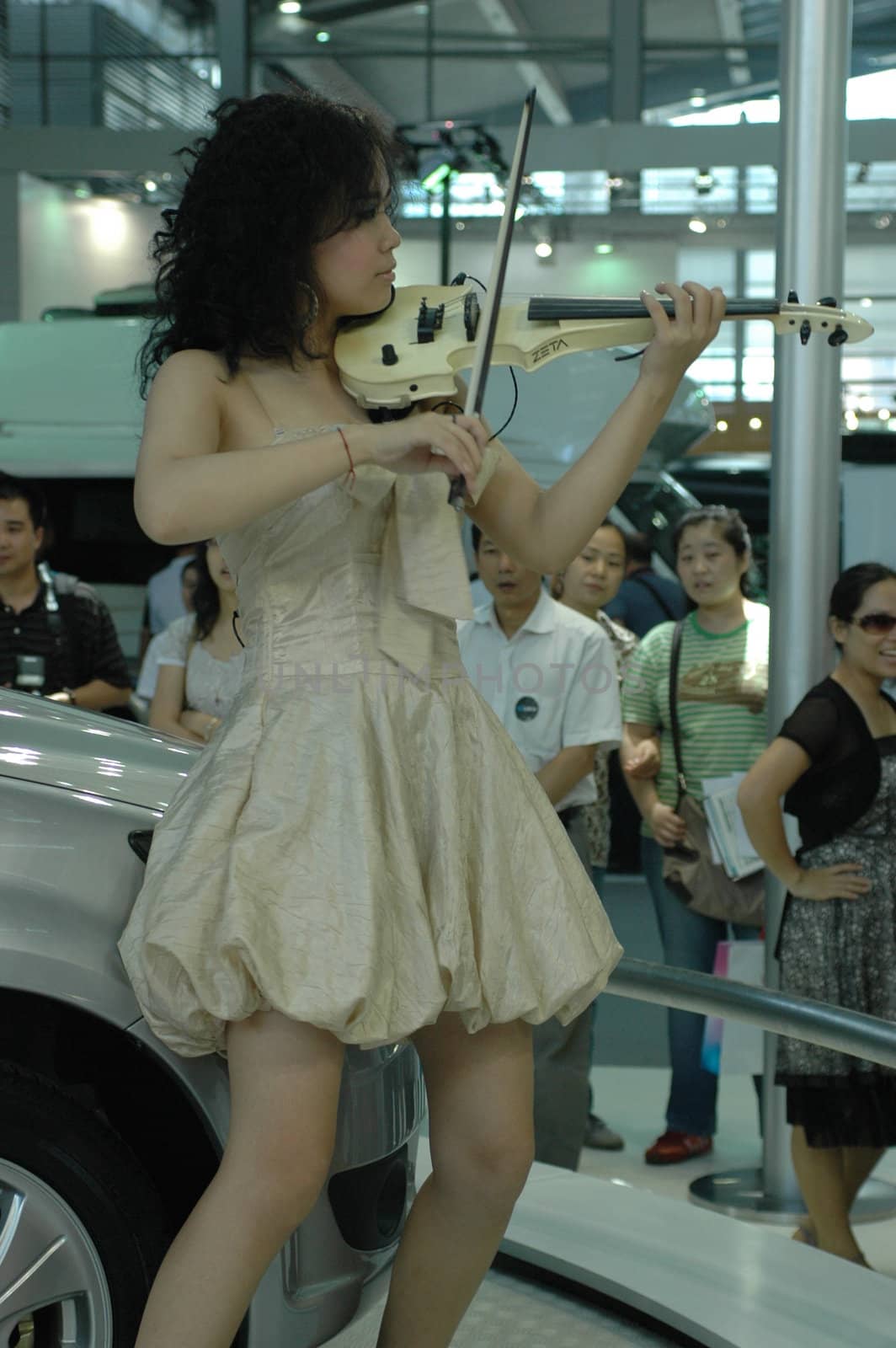 Chinese model. Girls promoting modern cars during Shenzhen Moto - car show in China.