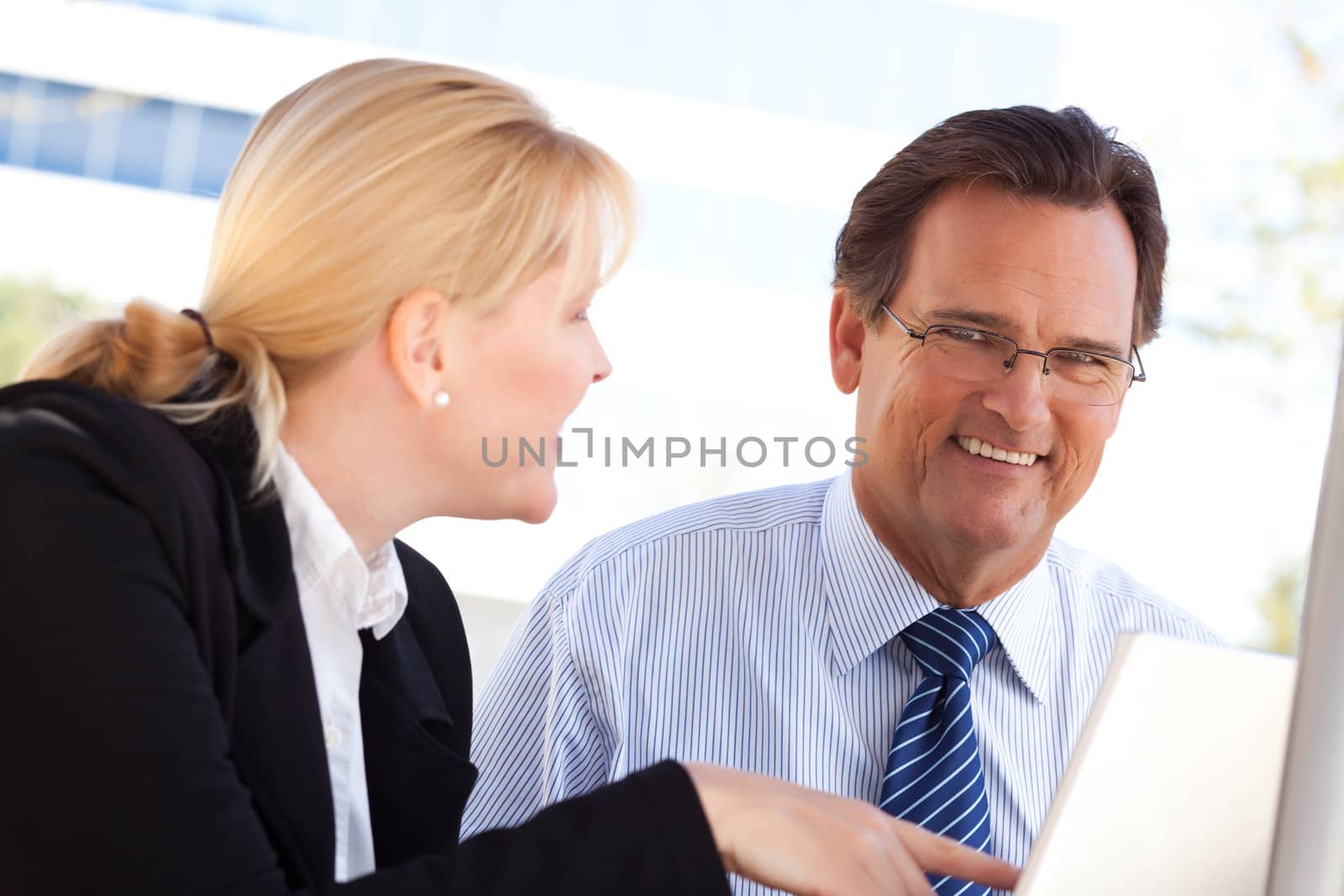 Handsome Businessman Working on the Laptop with Attractive Female Colleague Outdoors.
