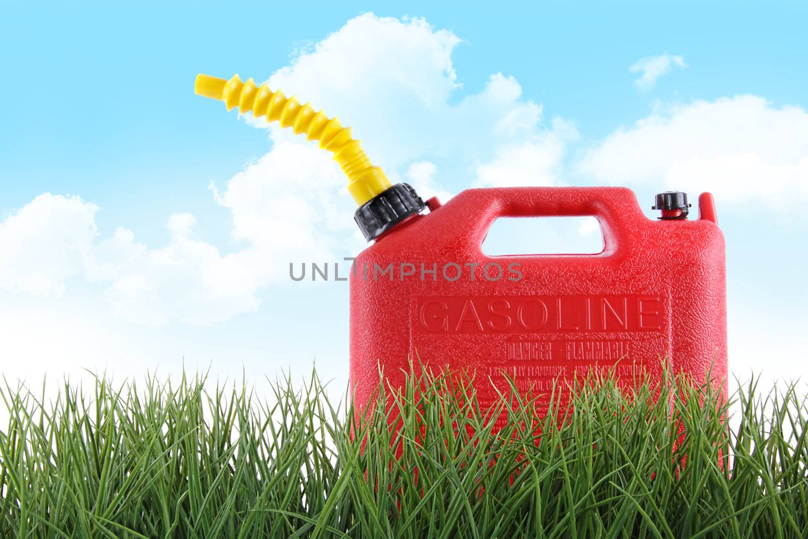 Plastic gas can in grass against white background