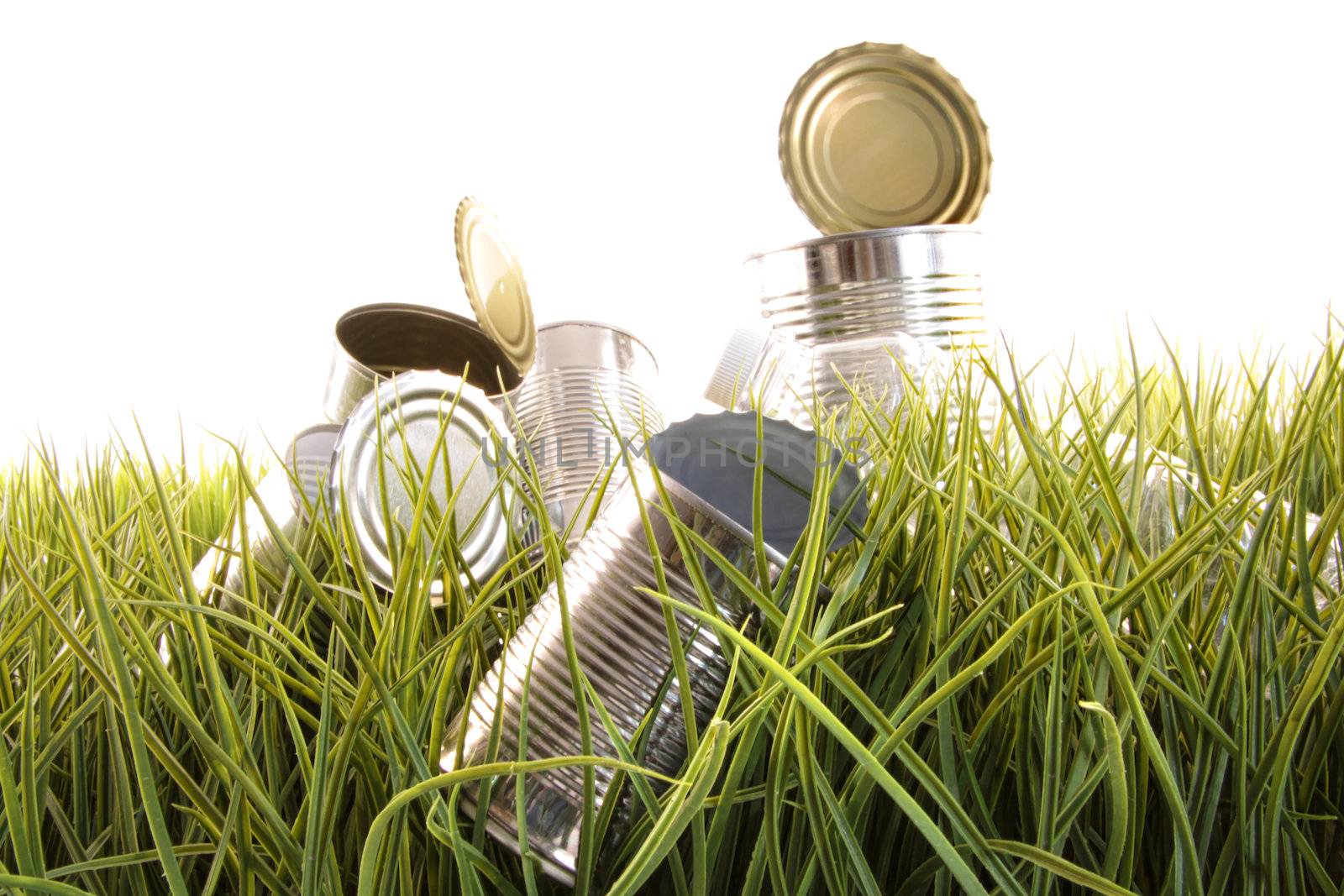 Forgotten empty cans and bottles laying in the grass