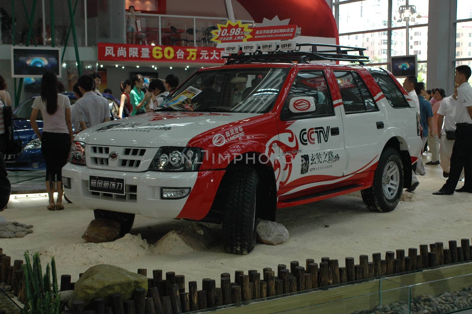 China, Shenzhen Moto - car show in exhibition center. Visitors watching European, American and Chinese cars. Crowd of people interested in newest moto technology.