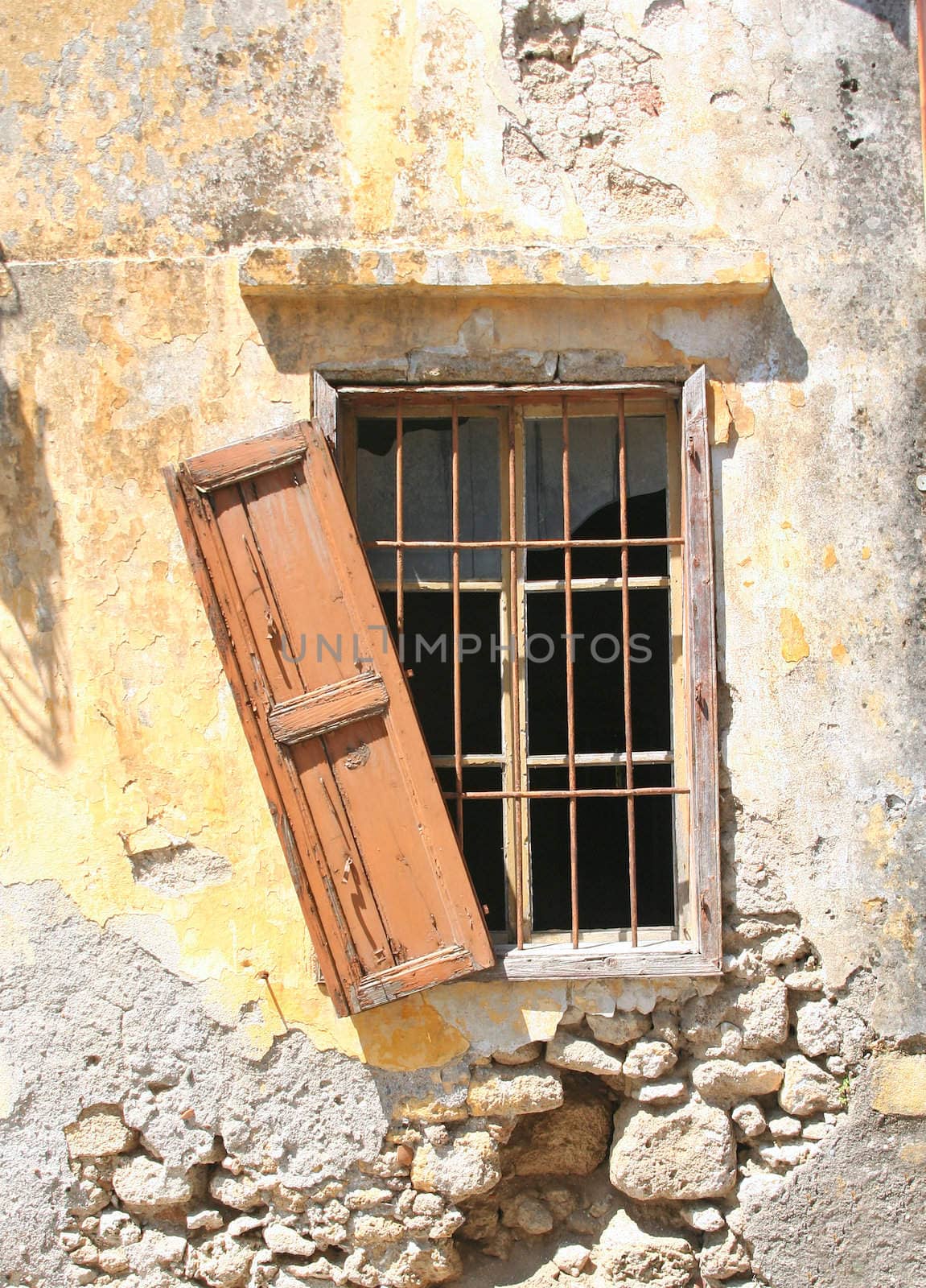 Broken window of an old house in Rhodes, Greece