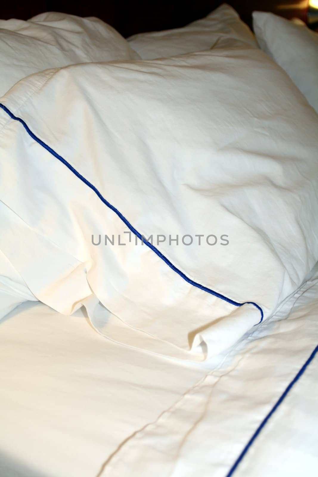 A hotel bed with clean, white linens