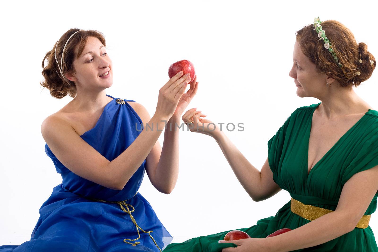 Two ladies in antique dress and apples on white background
